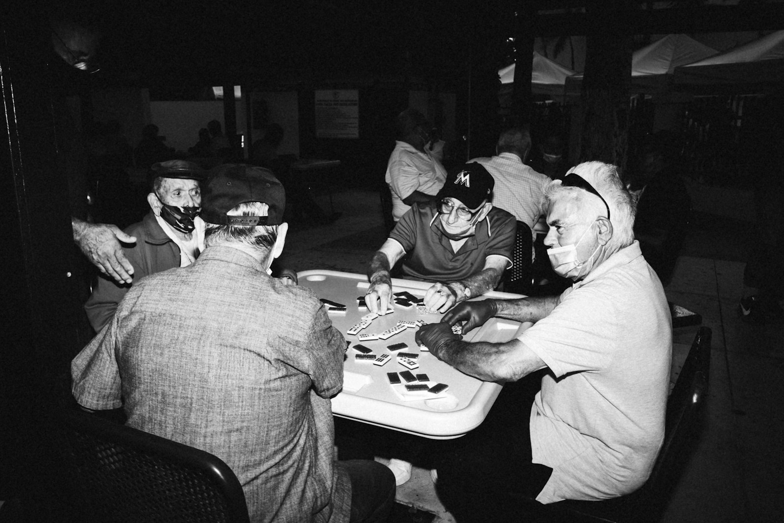 a group of men sitting around a table playing a game